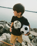 Dino On A Bike Organic Cotton T-shirt > Deux Par Deux (Glow in the Dark)
